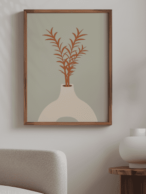 Minimalist botanical art print featuring terracotta-colored leaves in a rounded white vase on a sage green background in a wooden frame
