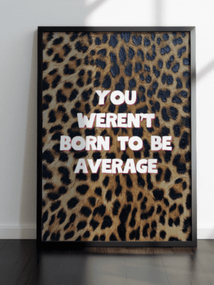 A framed motivational art print featuring the text "You Weren't Born To Be Average" in white bold letters with a pink shadow, set against a realistic leopard animal print background.
