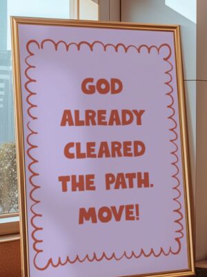 A framed art print with a lavender background and orange text reading "God already cleared the path. Move!" featuring a red scalloped border.
