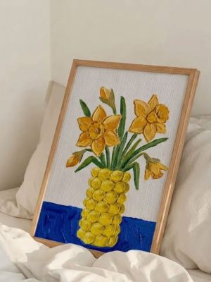 Yellow daffodil still life art print featuring bright daffodil flowers arranged in a yellow vase on a blue surface, aesthetic botanical floral wall art for home decor.